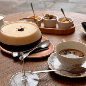Espresso martini with coffee and finger food on a café table in front of the cathedral in Como, Italy. UGC solutions for small hotels